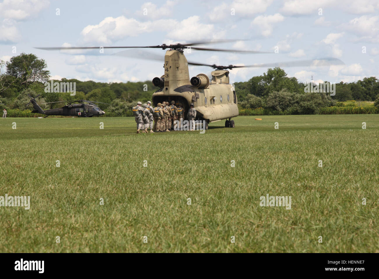 International paratroopers board a CH-47 Chinook during Leapfest in West Kingston, R.I., July 29, 2014. Leapfest is an Airborne parachute competition sponsored by the Rhode Island National Guard to promote high level technical training within the International Airborne community. (U.S. Army photo by Spc. Joseph Cathey/Released) Leapfest XXXI 140730-A-PG822-339 Stock Photo