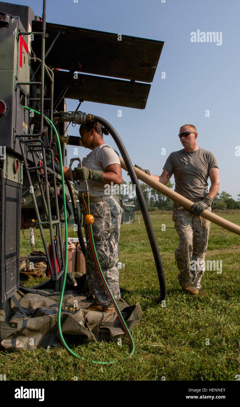 Kentucky National Guardsmen, Spc. Danielle Randolph and Pvt. 1st. Class Adam Watts, both assigned to the 1204th Aviation Support Battalion, perform an aqua glow test to assess sediment and pollution levels in fuel, Aug. 1, during Vibrant Response 14 at Forward Operating Base Nighthawk, Camp Atterbury, Ind. Vibrant Response is a U.S. Northern Command-sponsored field training exercise for chemical, biological, radiological, nuclear and high-yield explosive consequence management forces designed to improve their ability to respond to catastrophic incidents. (U.S. Army photo by Sgt. Dani Salvatore Stock Photo