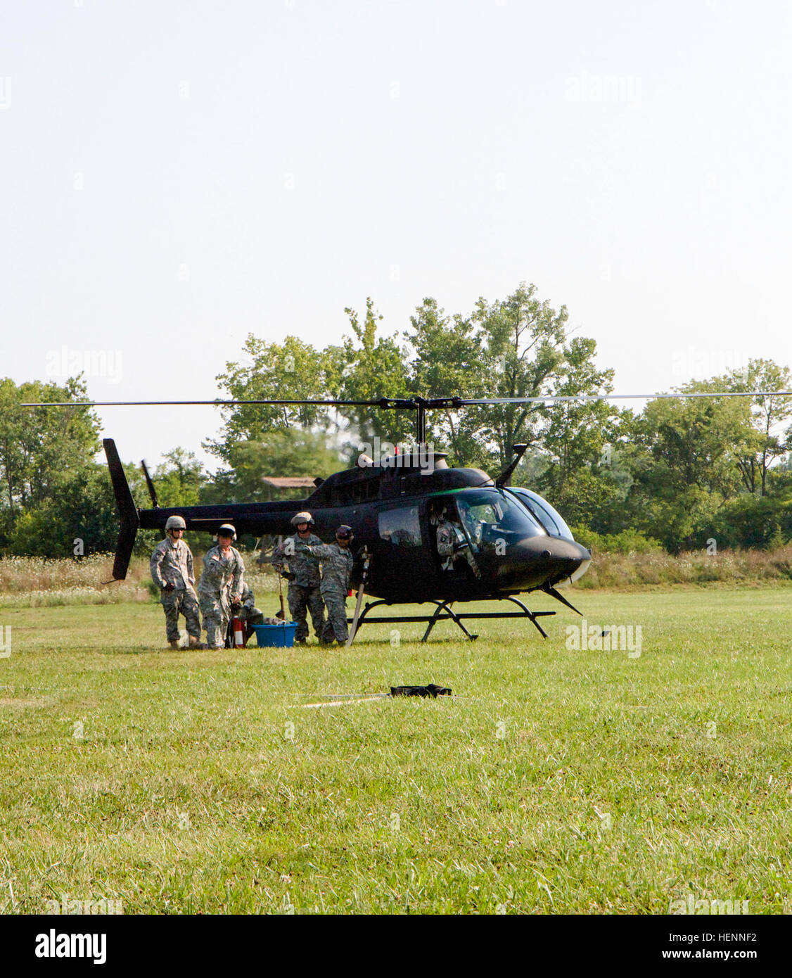 Kentucky National Guardsmen assigned to the 1204th Aviation Support Battalion, re-fuel a Blackhawk helicopter, Aug. 1, during the Vibrant Response 14 exercise at Forward Operating Base Nighthawk, Camp Atterbury, Ind. Vibrant Response is a U.S. Northern Command-sponsored field training exercise for chemical, biological, radiological, nuclear and high-yield explosive consequence management forces designed to improve their ability to respond to catastrophic incidents. (U.S. Army photo by Sgt. Dani Salvatore, 27th Public Affairs Detachment) 1204th Aviation Support Battalion 140801-A-HD862-010 Stock Photo