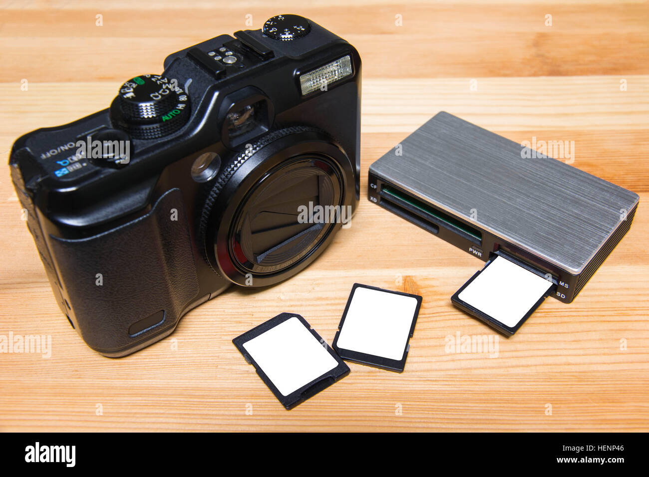 usb card reader with 3 cards and camera on wooden table ready to use Stock Photo