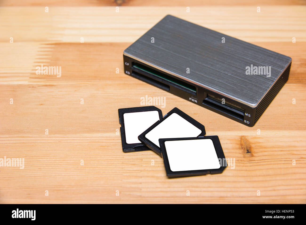usb card reader with 3 cards on wooden table Stock Photo