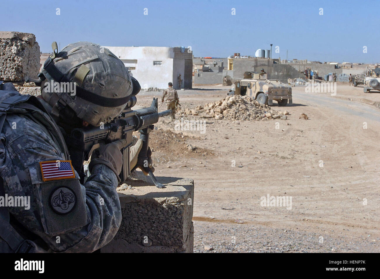 Sgt. Alejandro Cruz scans the area through the scope of his M4 assault rifle after hearing small-arms fire during a raid in Mosul, Iraq, April 17. Cruz is a tanker in Killer Troop, 3rd Squadron, 3d Armored Cavalry Regiment from Fort Hood, Texas. IA, CF raids on Mosul builds bonds between Armies 85258 Stock Photo