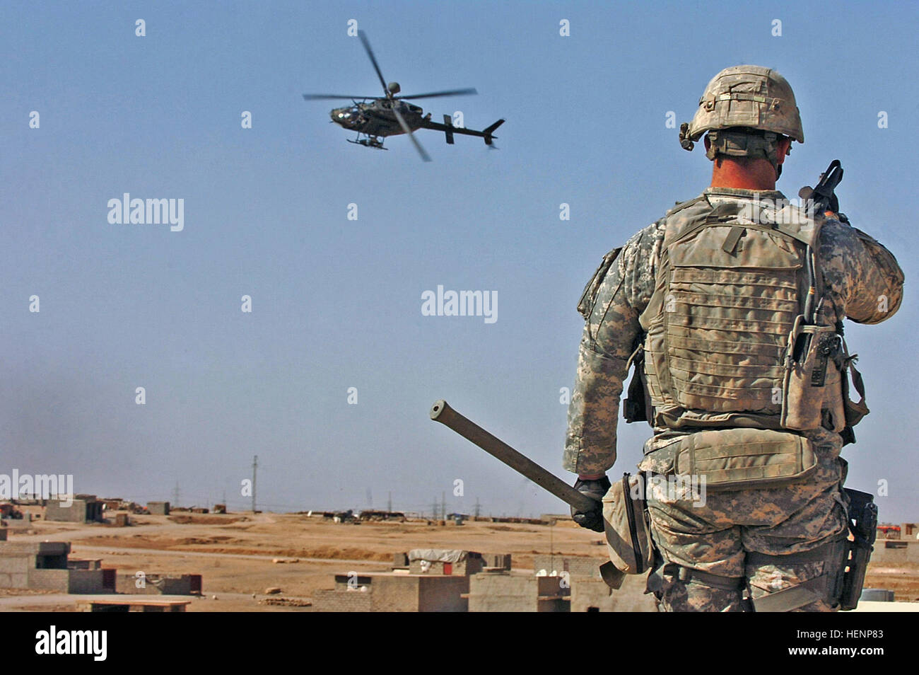 First Lt. Peter Cacossa directs an OH-58 Kiowa helicopter from a rooftop towards the sound of small-arms fire heard during a raid in Mosul, Iraq, April 17. Kiowas support troops on the ground in contact. Cacossa is a platoon leader in Heavy Company, 3rd Squadron, 3d Armored Cavalry Regiment from Fort Hood, Texas. IA, CF raids on Mosul builds bonds between Armies 85259 Stock Photo