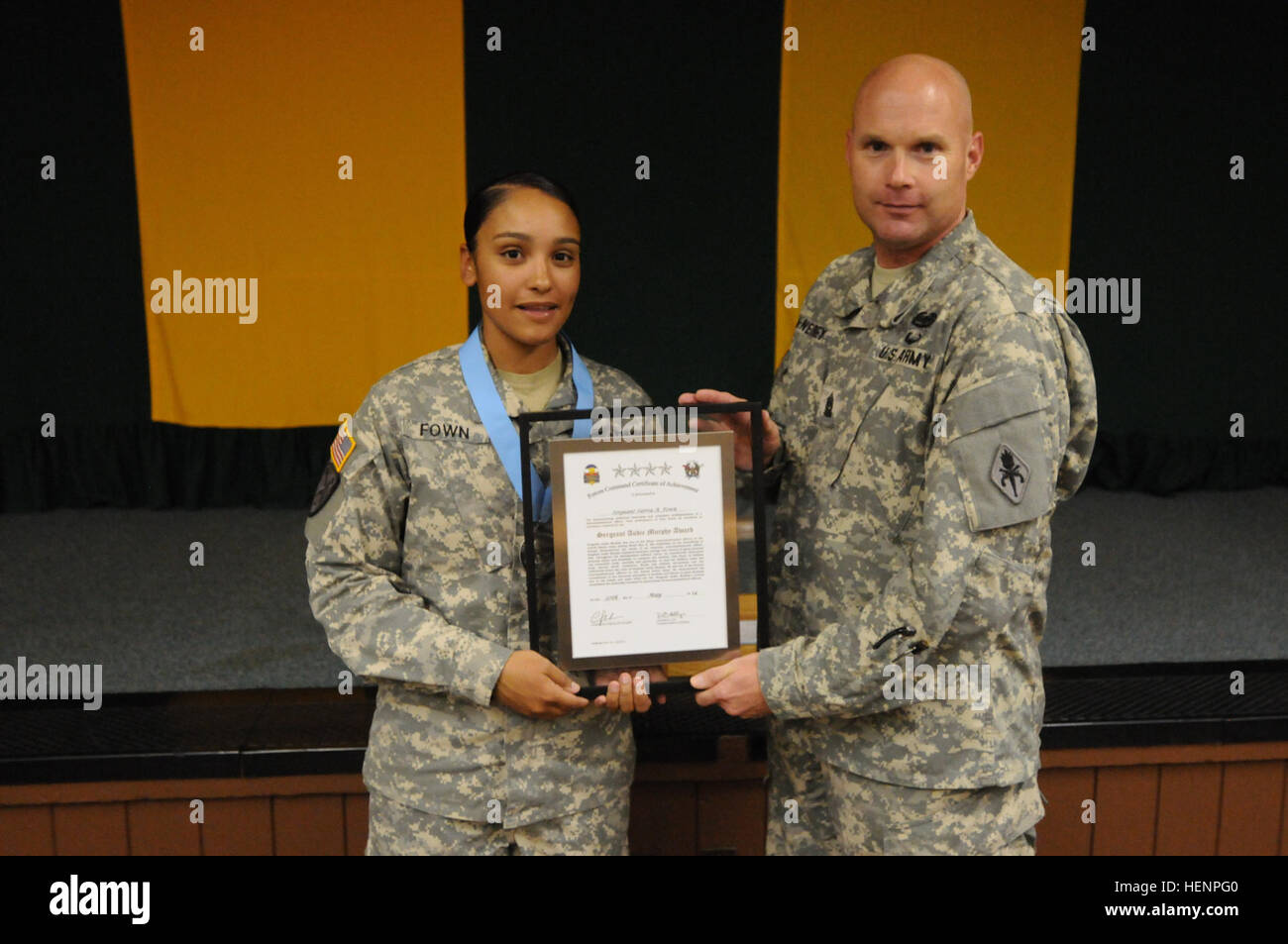 Command Sgt. Maj. John McNeirney, Military Police Regimental and U.S. Army Military Police School, hands Sgt. Sierra Fown, military police officer, 110th MP Company, 759th MP Battalion, her certificate for being inducted into the Sgt. Audie Murphy Club at Fort Carson, Colo., Aug. 21, 2014. (U.S. Army photo by Sgt. Eric Glassey, 4th Infantry Division PAO) MP CSM visits Fort Carson 140821-A-RY828-648 Stock Photo