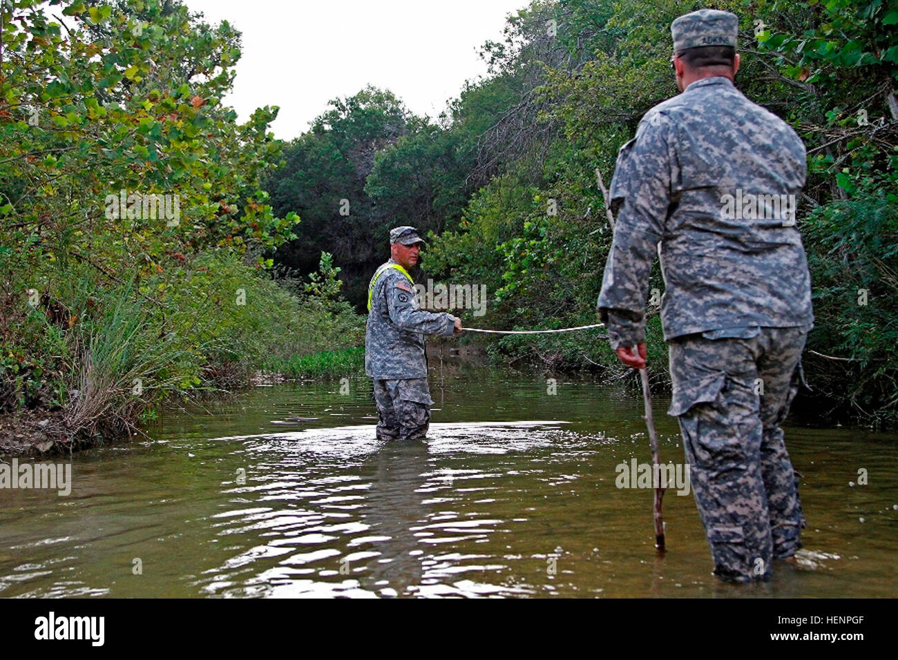 Staff Sgt. Robert Owen (left) and Spc. Zachary Adkins, both combat engineers assigned to Headquarters and Headquarters Company 'Hammer,' 1st Brigade Combat Team 'Ironhorse,' 1st Cavalry Division, measure distance between two points in a stream to determine its velocity during First Team Training Aug. 21 at Fort Hood, Texas. The 1st Cavalry Division has emphasized the importance of continued professional development every Thursday during First Team Training. (U.S. Army photo by Spc. Paige Behringer, 1BCT PAO, 1st Cav. Div.) Soldiers train, build teams, conduct counseling for First Team Training Stock Photo