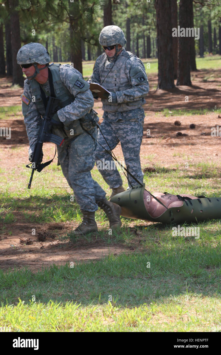 U.S. Army Staff Sgt. Thomas L. Kerfoot, a senior engagement team leader with Alpha Battery, 3rd Squadron, 2nd Air Defense Artillery Regiment, 31st ADA Brigade, pulls a simulated casualty on a SKED evacuation tool toward a casualty collection point during a stress shoot at Fort Bragg, N.C., Aug. 26, 2014.   (U.S. Army photo by Staff Sgt. Todd Pouliot/Released) U.S. Army Staff Sgt. Thomas L. Kerfoot, a senior engagement team leader with Alpha Battery, 3rd Squadron, 2nd Air Defense Artillery Regiment, 31st ADA Brigade, pulls a simulated casualty on a SKED evacuation 140826-A-TP284-003 Stock Photo