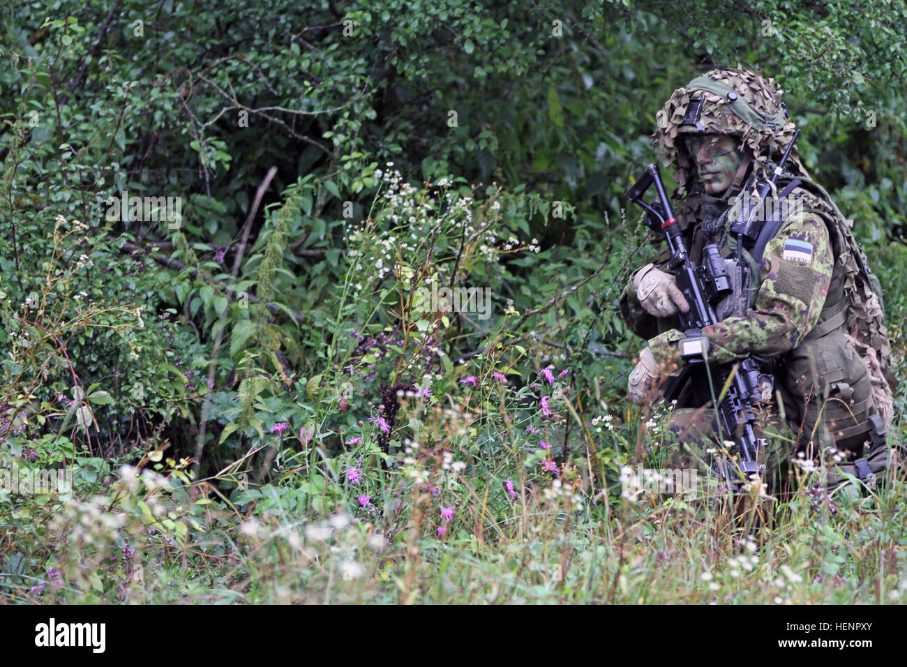 Estonian Land Force Sgt. 1st Class Andrei Kurotskin provides security