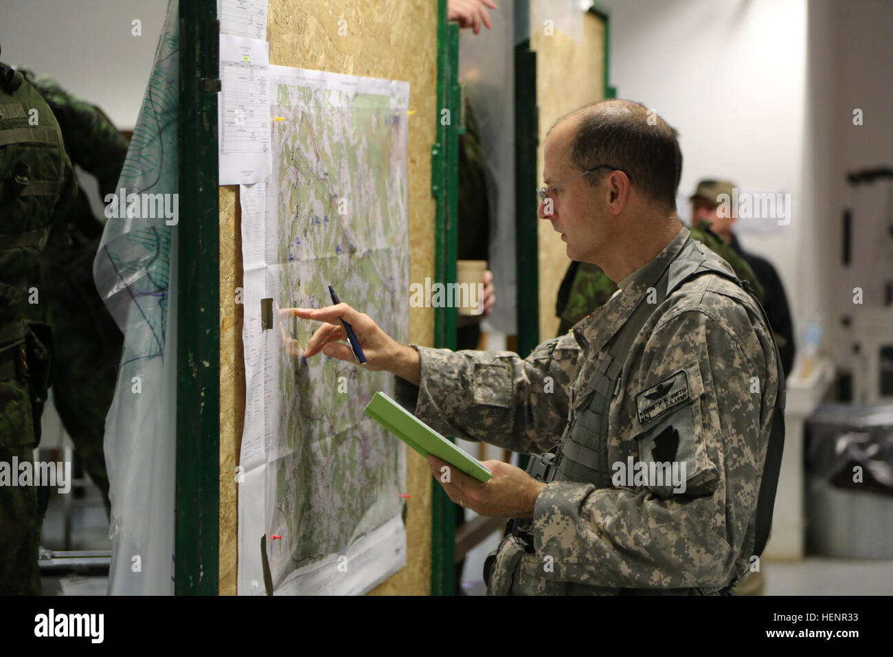 U.S. Army Maj. Kenneth Smith of Headquarters, Headquarters Company, 173rd Airborne Brigade, goes over a map overlay during training exercise Saber Junction 2014 at the Joint Multinational Readiness Center in Hohenfels, Germany, Aug. 31, 2014. Saber Junction 2014 prepares U.S., NATO allies and European security partners to conduct unified land operations through the simultaneous combination of offensive, defensive, and stability operations appropriate to the mission and the environment.  More information about Saber Junction 2014 can be found at http://www.eur.army.mil/SaberJunction/ (U.S. Army Stock Photo