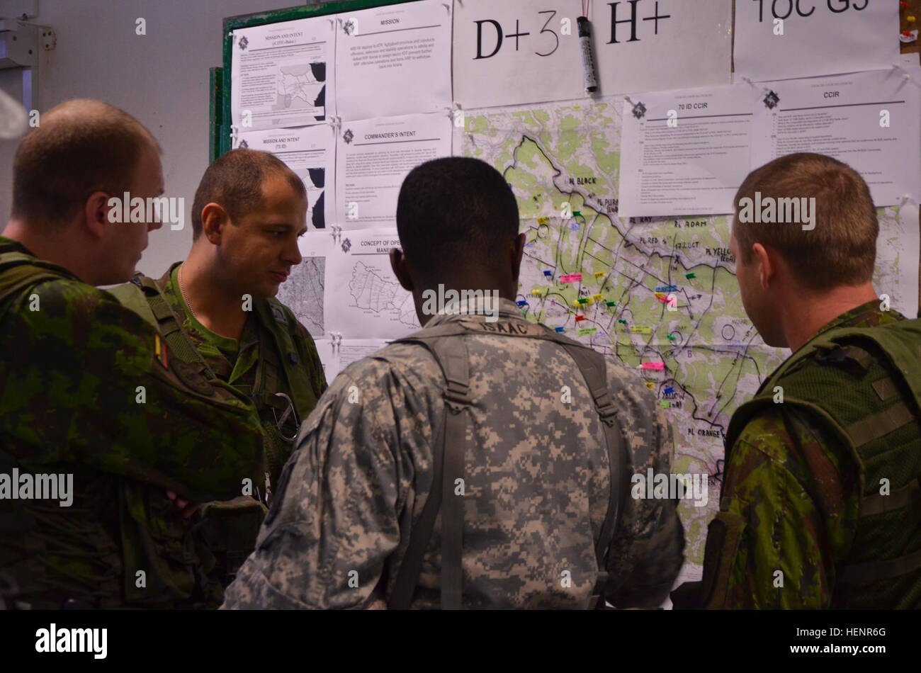 Lithuanian Land Force Capt. Darius Zukas of 'Iron Wolf' Mechanized Infantry Brigade reviews map locations during training exercise Saber Junction 2014 at the Joint Multinational Readiness Center in Hohenfels, Germany, Sept. 2, 2014. Saber Junction 2014 prepares U.S., NATO allies, and European security partners to conduct unified land operations through the simultaneous combination of offensive, defensive, and stability operations appropriate to the mission and the environment. More information about Saber Junction 2014 can be found at http://www.eur.army.mil/SaberJunction/. (U.S. Army photo by Stock Photo
