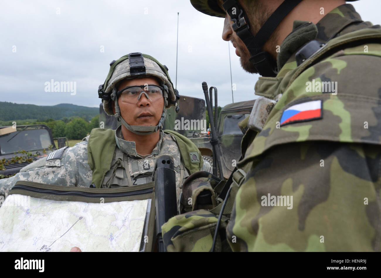 A U.S. Soldier, left, with the 500th Engineer Company, 15th Engineer Battalion and a Czech soldier with the Mechanized Infantry Brigade review a map Sept. 3, 2014, at the Joint Multinational Readiness Center in Hohenfels, Germany, during exercise Saber Junction 2014. Saber Junction is a U.S. Army Europe-led exercise designed to prepare U.S., NATO and international partner forces for unified land operations. (U.S. Army photo by Pvt. Lloyd Villanueva/Released) A U.S. Soldier, left, with the 500th Engineer Company, 15th Engineer Battalion and a Czech soldier with the Mechanized Infantry Brigade r Stock Photo