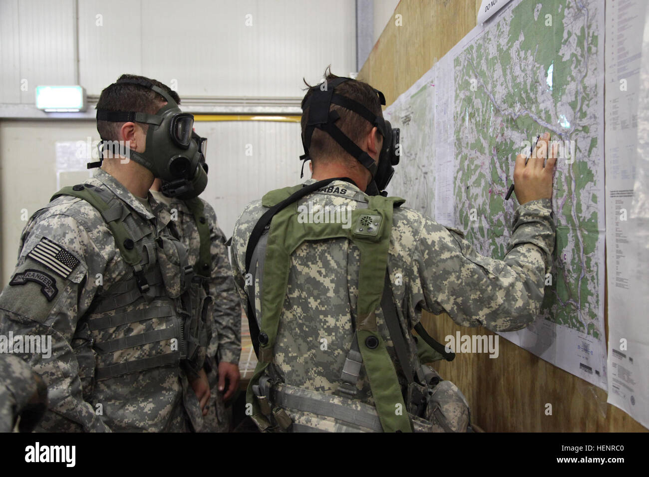 U.S. Soldiers reference a map during a simulated chemical attack while participating in training exercise Saber Junction 2014 at the Joint Multinational Readiness Center in Hohenfels, Germany, Sept. 4, 2014. Saber Junction 2014 prepares U.S., NATO allies and European security partners to conduct unified land operations through the simultaneous combination of offensive, defensive and stability operations appropriate to the mission and the environment. More information about Saber Junction 2014 can be found at http://www.eur.army.mil/SaberJunction/. (U.S. Army photo by Staff Sgt. Carol A. Lehman Stock Photo