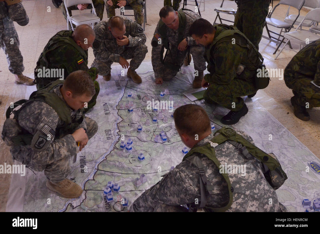 U.S. Soldiers and Lithuanian soldiers explain their soldiers' locations on a combined arms rehearsal map during training exercise Saber Junction 2014 at the Joint Multinational Readiness Center in Hohenfels, Germany, Sept. 4, 2014. Saber Junction 2014 prepares U.S., NATO allies, and European security partners to conduct unified land operations through the simultaneous combination of offensive, defensive, and stability operations appropriate to the mission and the environment. More information about Saber Junction 2014 can be found at http://www.eur.army.mil/SaberJunction/. (U.S. Army photo by  Stock Photo