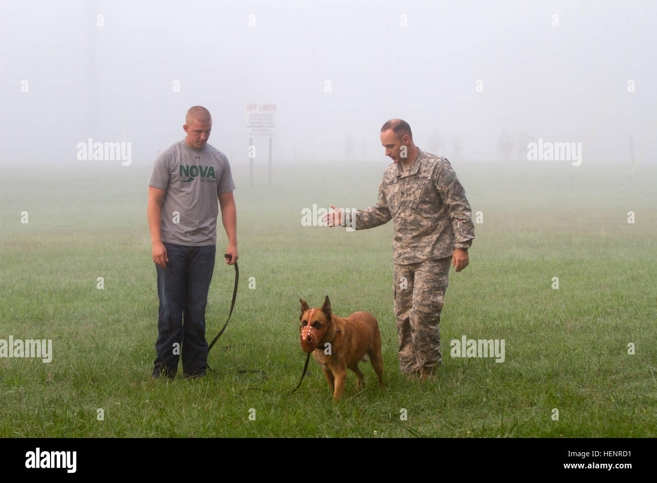 Staff Sgt. Jonathan Rose, the kennel master for the 510th Military Police Detachment, 716th Military Police Battalion, supported by the 101st Sustainment Brigade, 101st Airborne Division, gives instruction to Pfc. Jared Bridges, a dog handler also with the 510th MP Det., during a retirement assessment for Arno, a military working dog, Sept. 4 at Fort Campbell, Ky. Arno has served for more than six years, and brings and brings a search asset to the military that cannot be replicated by man nor machine. (U.S. Army photo by Sgt. Leejay Lockhart, 101st Sustainment Brigade Public Affairs) Soldiers  Stock Photo