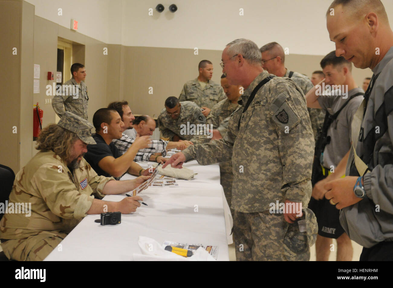 Cast members of the FX show 'Sons of Anarchy' sign autographs for service members during a meet and greet, March 16, at Joint Base Balad, Iraq. 'Sons of Anarchy' actors visit Taji, JBB 261237 Stock Photo