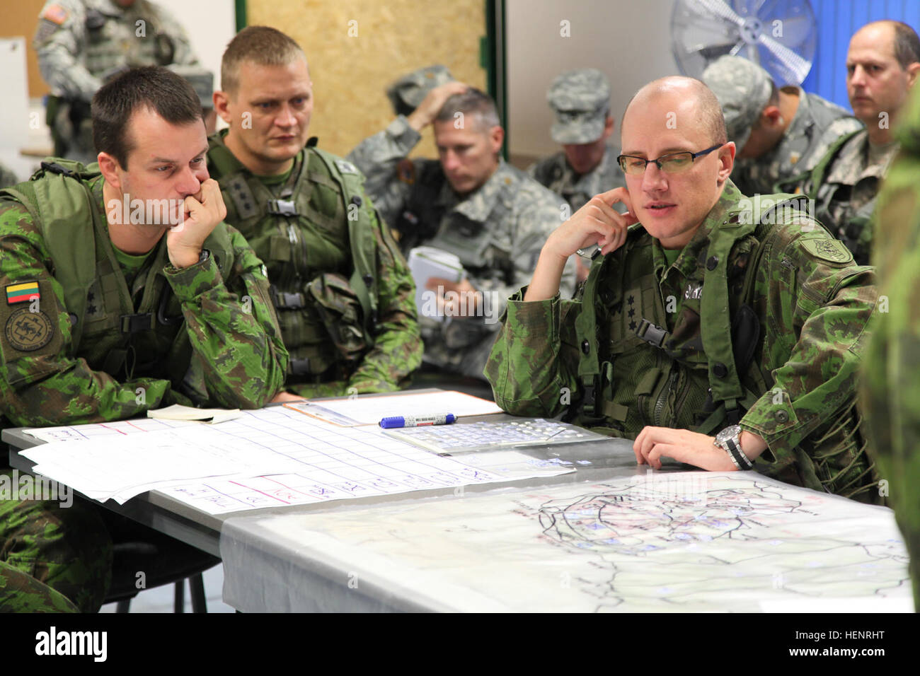 Lithuanian soldiers of 'Iron Wolf' Mechanized Infantry Brigade study a map while working to plan a mission during training exercise Saber Junction 2014 at the Joint Multinational Readiness Center in Hohenfels, Germany, Sept. 6, 2014. Saber Junction 2014 prepares U.S., NATO allies and European security partners to conduct unified land operations through the simultaneous combination of offensive, defensive and stability operations appropriate to the mission and the environment.  More information about Saber Junction 2014 can be found at http://www.eur.army.mil/SaberJunction/ (U.S. Army photo by  Stock Photo
