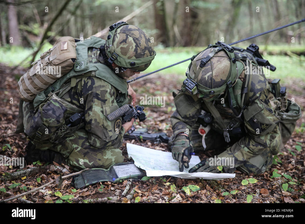 Czech soldiers of 41st Mechanized Battalion, 4th Rapid Deployment Brigade, discuss terrain features while referencing a map during training exercise Saber Junction 2014 at the Joint Multinational Readiness Center in Hohenfels, Germany, Sept. 6, 2014. Saber Junction 2014 prepares U.S., NATO allies and European security partners to conduct unified land operations through the simultaneous combination of offensive, defensive and stability operations appropriate to the mission and the environment. More information about Saber Junction 2014 can be found at http://www.eur.army.mil/SaberJunction/ (U.S Stock Photo
