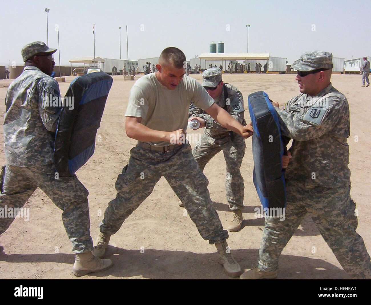 Minnapolis, Minn., native Spc. Bryan Carlson, tower guard, Btry. A, 1-21 FA, practices defensive moves after being sprayed with oleoresin capiscum during a class at Camp Bucca, Iraq, July 28. Carlson, who missed the battalion's training at Fort Bliss, Texas, said the spray is similar to spending six hours in a nuclear, biological and chemical training chamber. (Photo by Spc. Allison Churchill, 41st Fires Bde. PAO) Assassins finish OC spray training 110661 Stock Photo