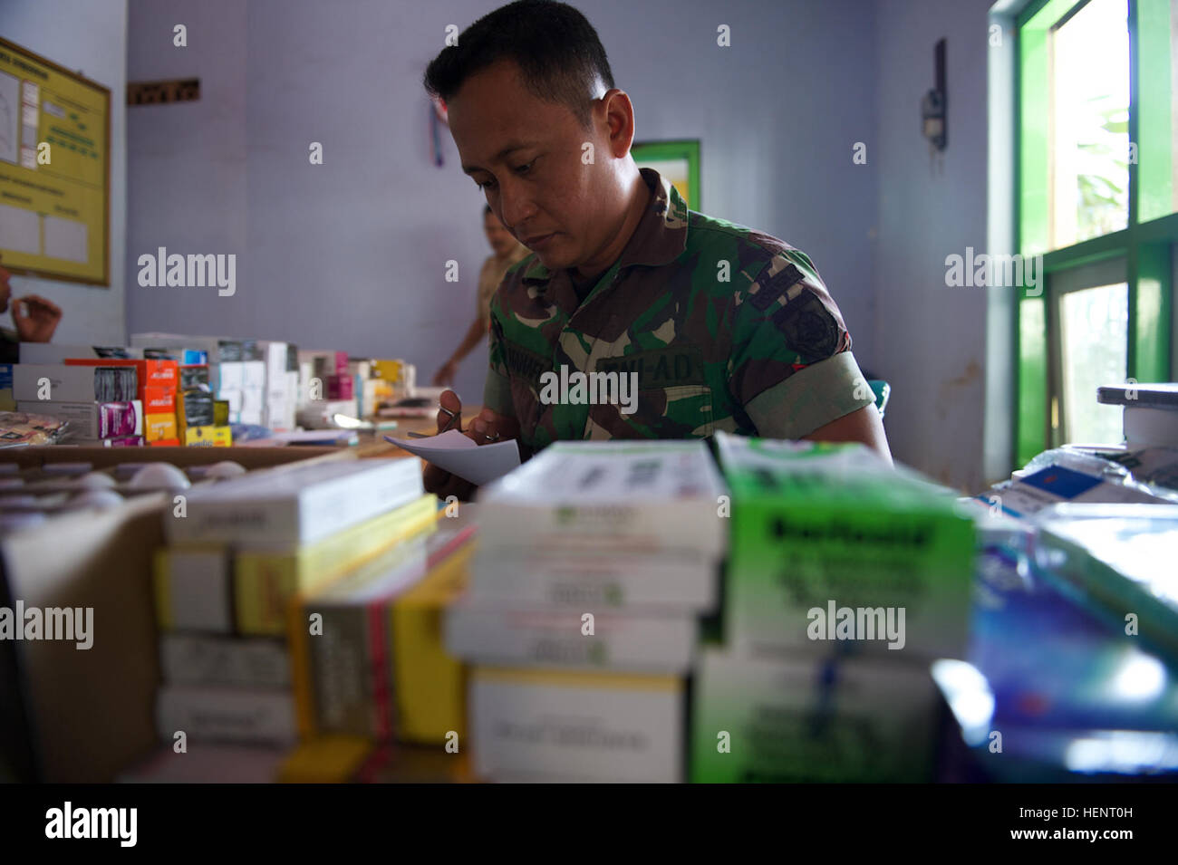 Sgt. Serda Hanafi, a nurse with the Indonesian Armed Force's 2nd Medical Battalion prepares descriptions during the Cooperative Health Engagement held in Sumber Waru Village, Situbundo, Indonesia, Sept. 15. The CHE was held in Support of Garuda Shield 2014, a bilateral, tactical military exercise sponsored by U.S. Army Pacific Command and hosted by the Indonesian Armed Forces. Approximately 1,200 personnel from U.S. Army and Indonesian Armed Forces will conduct a series of training events focused on peace support operations. (Photo by U.S. Army Sgt. Brooks Fletcher, 16th Mobile Public Affairs  Stock Photo