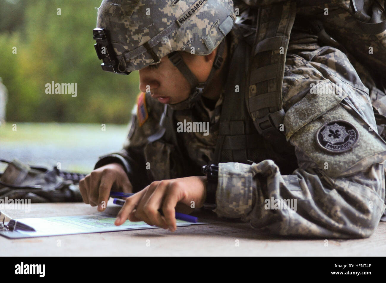 U.S. Army Spc. Felix Valle Garcia, assigned to C Troop, 1st Squadron, 2nd Cavalry Regiment, plots coordinates on a map during the land navigation portion of the  European Best Warrior Competition in Grafenwoehr, Germany, Sept. 14, 2014. The competition is a weeklong event that pushes Soldiers to the limits of their physical stamina, bearing, knowledge, adaptability and technical and tactical skills. The best warriors are ready and resilient Soldiers who live the Army values and lead from the front. (U.S. Army photo by Staff Sgt. Pablo N. Piedra/Released) European Best Warrior Competition 2014  Stock Photo