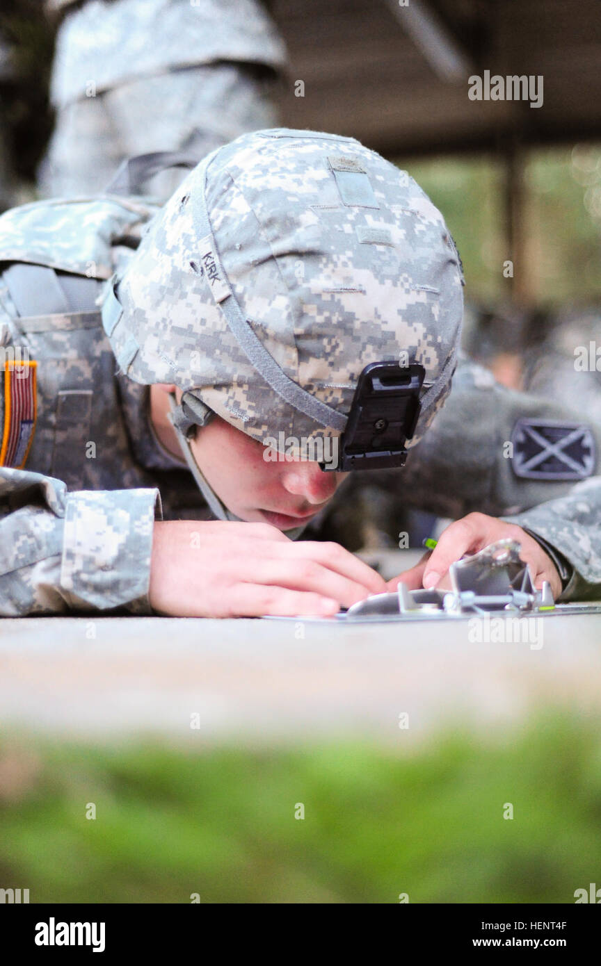 U.S. Army Pfc. Brandon Kirk, assigned to C Battery, 5th Battalion, 7th Air Defense Artillery Regiment, 10th Army Air and Missile Defense Command,  plots coordinates on a map during the land navigation portion of the  European Best Warrior Competition in Grafenwoehr, Germany, Sept. 14, 2014. The competition is a weeklong event that pushes Soldiers to the limits of their physical stamina, bearing, knowledge, adaptability and technical and tactical skills. The best warriors are ready and resilient Soldiers who live the Army values and lead from the front. (U.S. Army photo by Staff Sgt. Pablo N. P Stock Photo