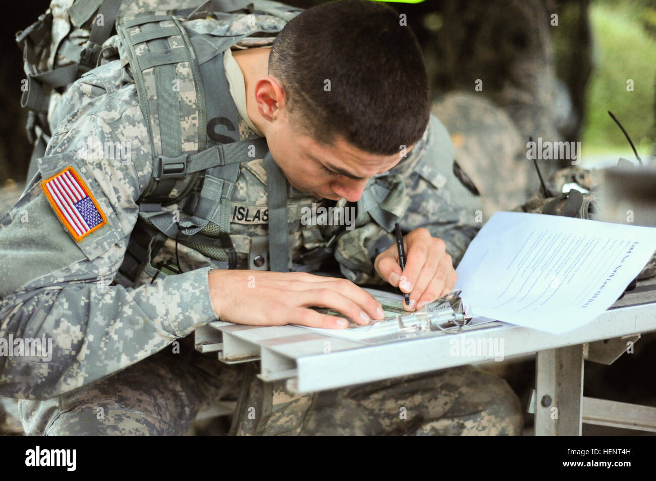 U.S. Army Spc. Paul Islas, assigned to D Company, 2-159th Attack Reconnaissance Battalion, 12th Combat Aviation Brigade,  plots coordinates on a map during the land navigation portion of the  European Best Warrior Competition in Grafenwoehr, Germany, Sept. 14, 2014. The competition is a weeklong event that pushes Soldiers to the limits of their physical stamina, bearing, knowledge, adaptability and technical and tactical skills. The best warriors are ready and resilient Soldiers who live the Army values and lead from the front. (U.S. Army photo by Staff Sgt. Pablo N. Piedra/Released) European  Stock Photo