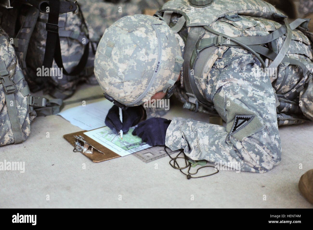 U.S. Army Pvt. Benjamin Ranew, assigned to B Company, 1st Battalion, 4th Infantry Regiment, Joint Multinational Training Command,  plots coordinates on a map during the land navigation portion of the  European Best Warrior Competition in Grafenwoehr, Germany, Sept. 14, 2014. The competition is a weeklong event that pushes Soldiers to the limits of their physical stamina, bearing, knowledge, adaptability and technical and tactical skills. The best warriors are ready and resilient Soldiers who live the Army values and lead from the front. (U.S. Army photo by Staff Sgt. Pablo N. Piedra/Released)  Stock Photo