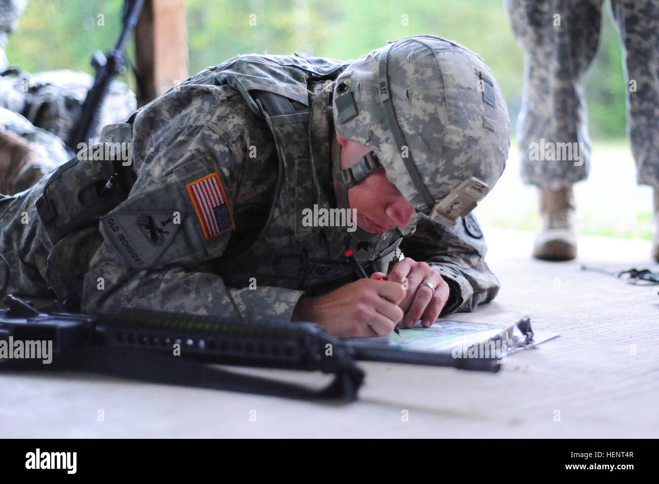 U.S. Army Sgt. Ricardo Ruiz, assigned to C Company, Allied Forces South Battalion, United States Army NATO Brigade,  plots coordinates on a map during the land navigation portion of the  European Best Warrior Competition in Grafenwoehr, Germany, Sept. 14, 2014. The competition is a weeklong event that pushes Soldiers to the limits of their physical stamina, bearing, knowledge, adaptability and technical and tactical skills. The best warriors are ready and resilient Soldiers who live the Army values and lead from the front. (U.S. Army photo by Staff Sgt. Pablo N. Piedra/Released) European Best  Stock Photo