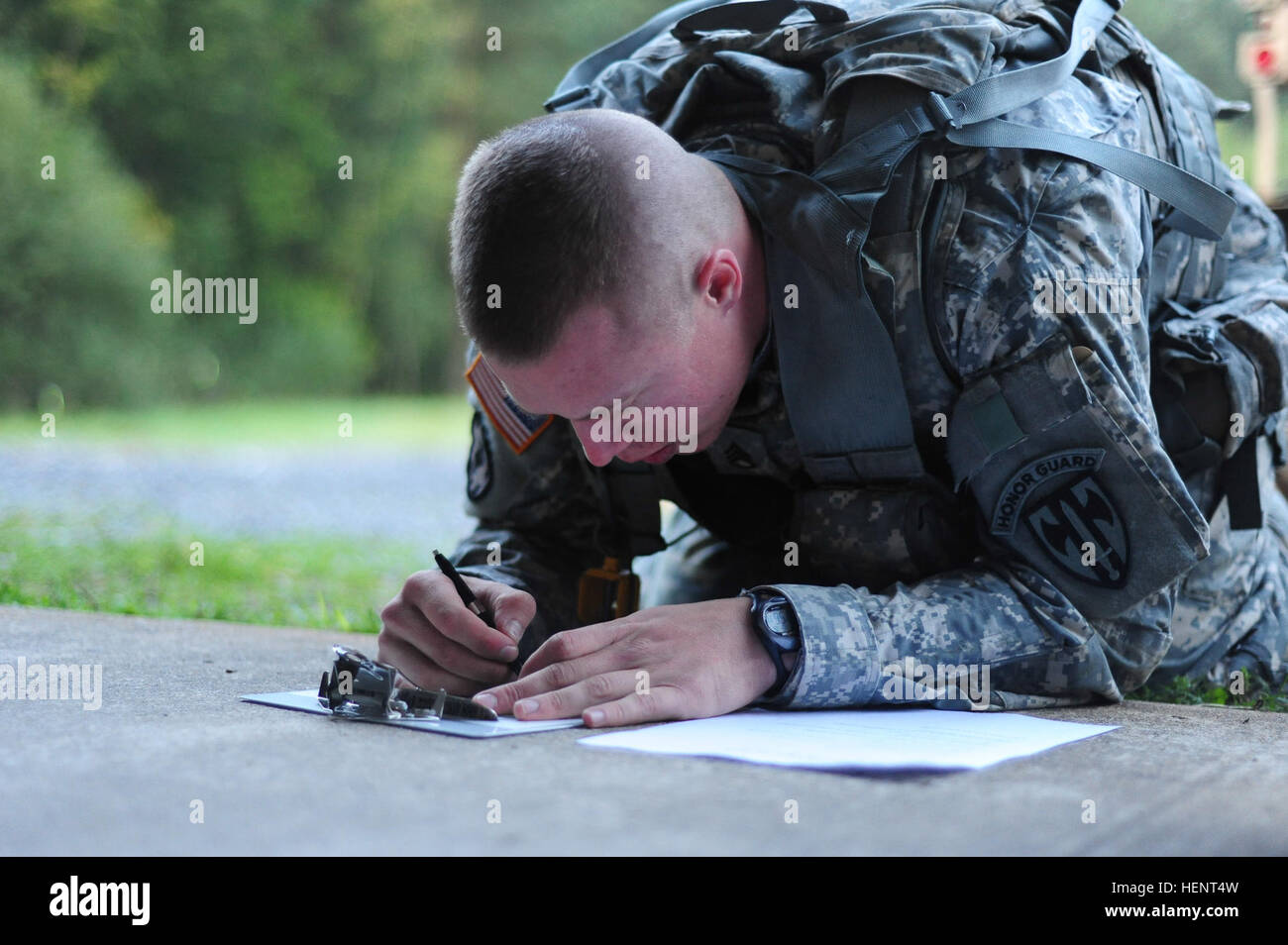 U.S. Army Staff Sgt. Jordan Stipp, assigned to 709th Military Police Battalion, 21st Theater Sustainment Command,  plots coordinates on a map during the land navigation portion of the  European Best Warrior Competition in Grafenwoehr, Germany, Sept. 14, 2014. The competition is a weeklong event that pushes Soldiers to the limits of their physical stamina, bearing, knowledge, adaptability and technical and tactical skills. The best warriors are ready and resilient Soldiers who live the Army values and lead from the front. (U.S. Army photo by Staff Sgt. Pablo N. Piedra/Released) European Best Wa Stock Photo