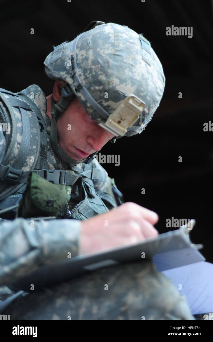 U.S. Army 1st Lt. Michael Theising, assigned to 15th Engineer Battalion, 21st Theater Sustainment Command ,  plots coordinates on a map during the land navigation portion of the  European Best Warrior Competition in Grafenwoehr, Germany, Sept. 14, 2014. The competition is a weeklong event that pushes Soldiers to the limits of their physical stamina, bearing, knowledge, adaptability and technical and tactical skills. The best warriors are ready and resilient Soldiers who live the Army values and lead from the front. (U.S. Army photo by Staff Sgt. Pablo N. Piedra/Released) European Best Warrior  Stock Photo