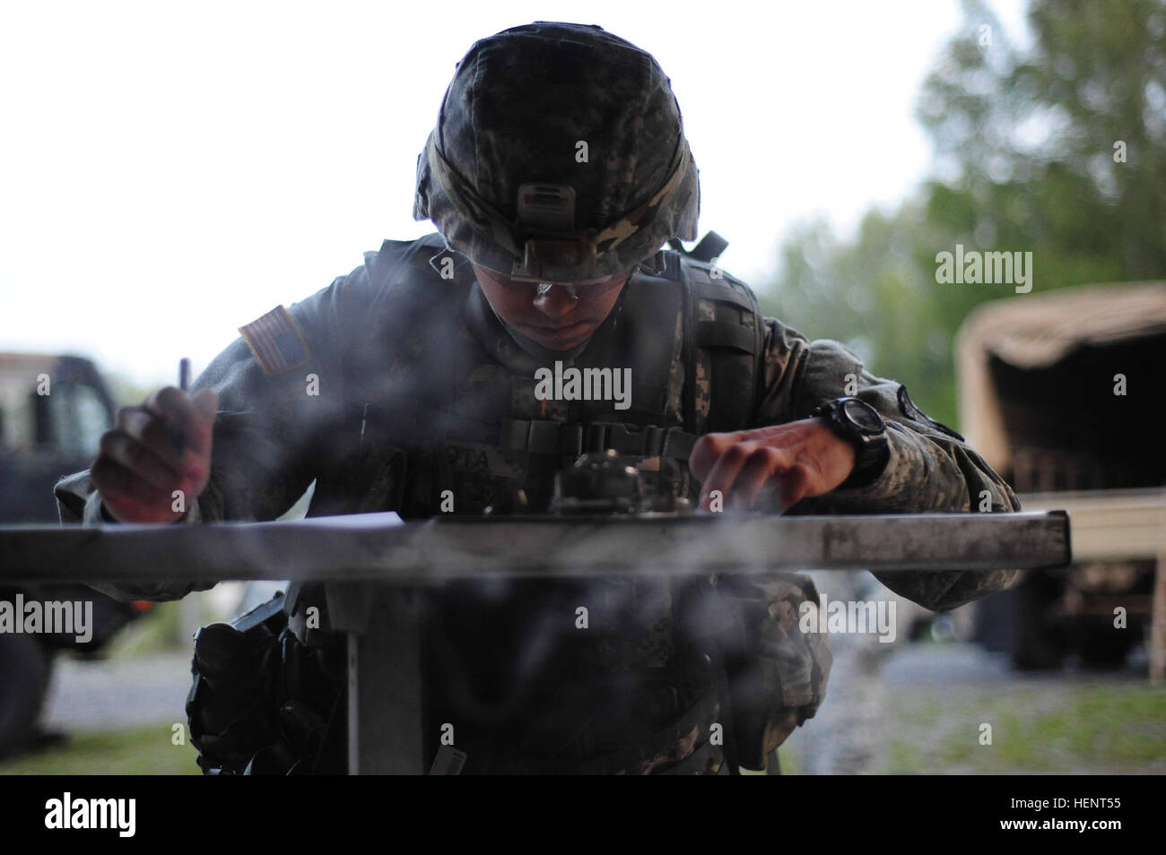 U.S. Army 2nd Lt. Ocatvio Mota, assigned to 5th Signal Command,  plots coordinates on a map during the land navigation portion of the  European Best Warrior Competition in Grafenwoehr, Germany, Sept. 14, 2014. The competition is a weeklong event that pushes Soldiers to the limits of their physical stamina, bearing, knowledge, adaptability and technical and tactical skills. The best warriors are ready and resilient Soldiers who live the Army values and lead from the front. (U.S. Army photo by Staff Sgt. Pablo N. Piedra/Released) European Best Warrior Competition 2014 140916-A-KG432-119 Stock Photo