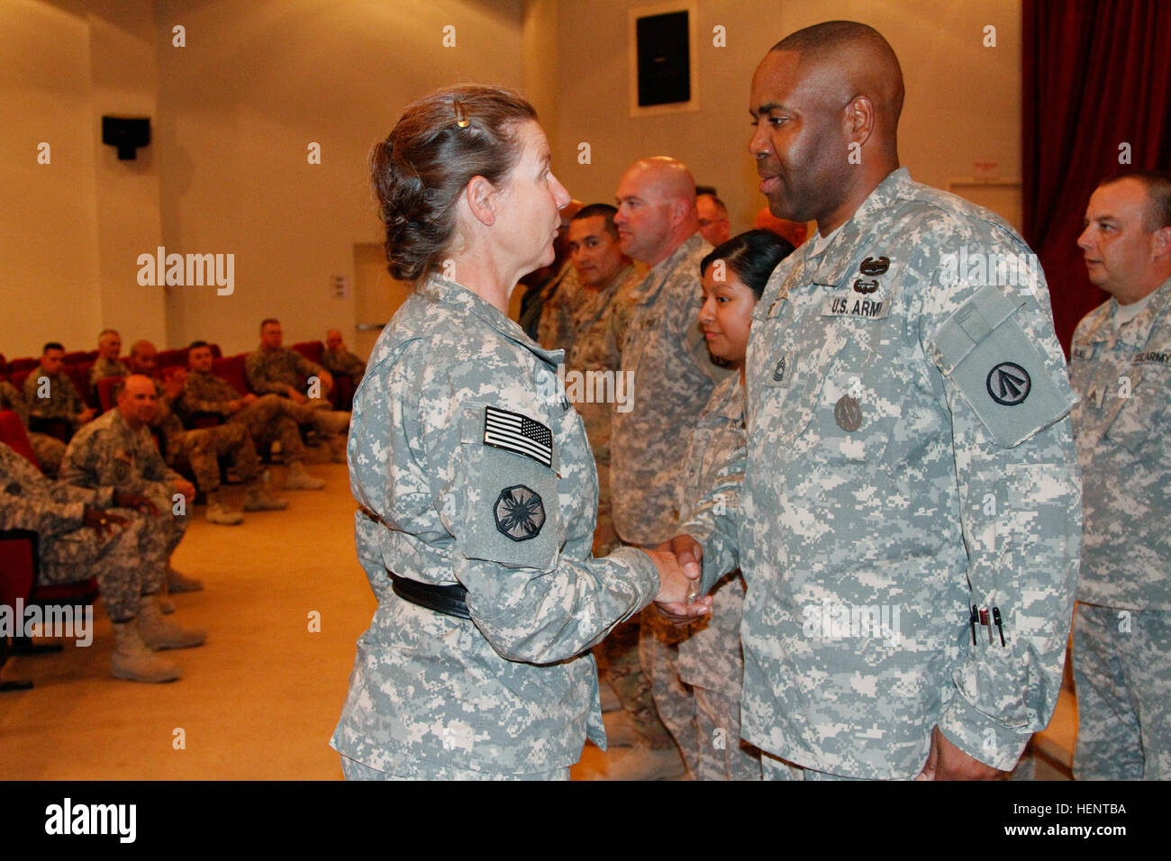 Maj. Gen. Susan A. Davidson, Commanding General of Surface Deployment and Distribution Command, gives a coin to a group of Soldiers who were selected by their respective units for their achievements, after her tour of the unit's operations at Port of Ash Shuaiba, Kuwait City, Kuwait, Sept. 18, 2014. The Soldiers were recognized for their accomplishments while deployed to Kuwait as they help the transition of Afghanistan. (U.S. Army photo by Sgt. Kyle Fisch/ U.S. Army Central Public Affairs) Maj. Gen. Susan A. Davidson Visits 840th Transportation Battalion 140918-A-PK277-321 Stock Photo