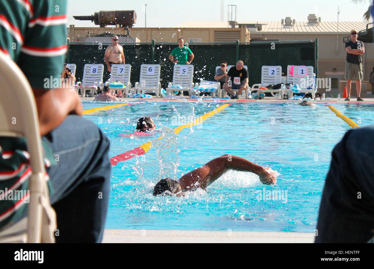 Capt. James Brigman, personnel recovery officer for the 3-238th General Support Aviation Battalion, swims his final lap during the first event of the Camp Arifjan triathlon, Sept. 21. Brigman is a native of Holt, Mich., and a member of the Michigan Army National Guard. He is serving on his third overseas tour. (U.S. Army photo by 1st Lt. Isra Pananon/released) Camp Arifjan triathlon boosts soldier morale 140921-A-ZJ446-107 Stock Photo