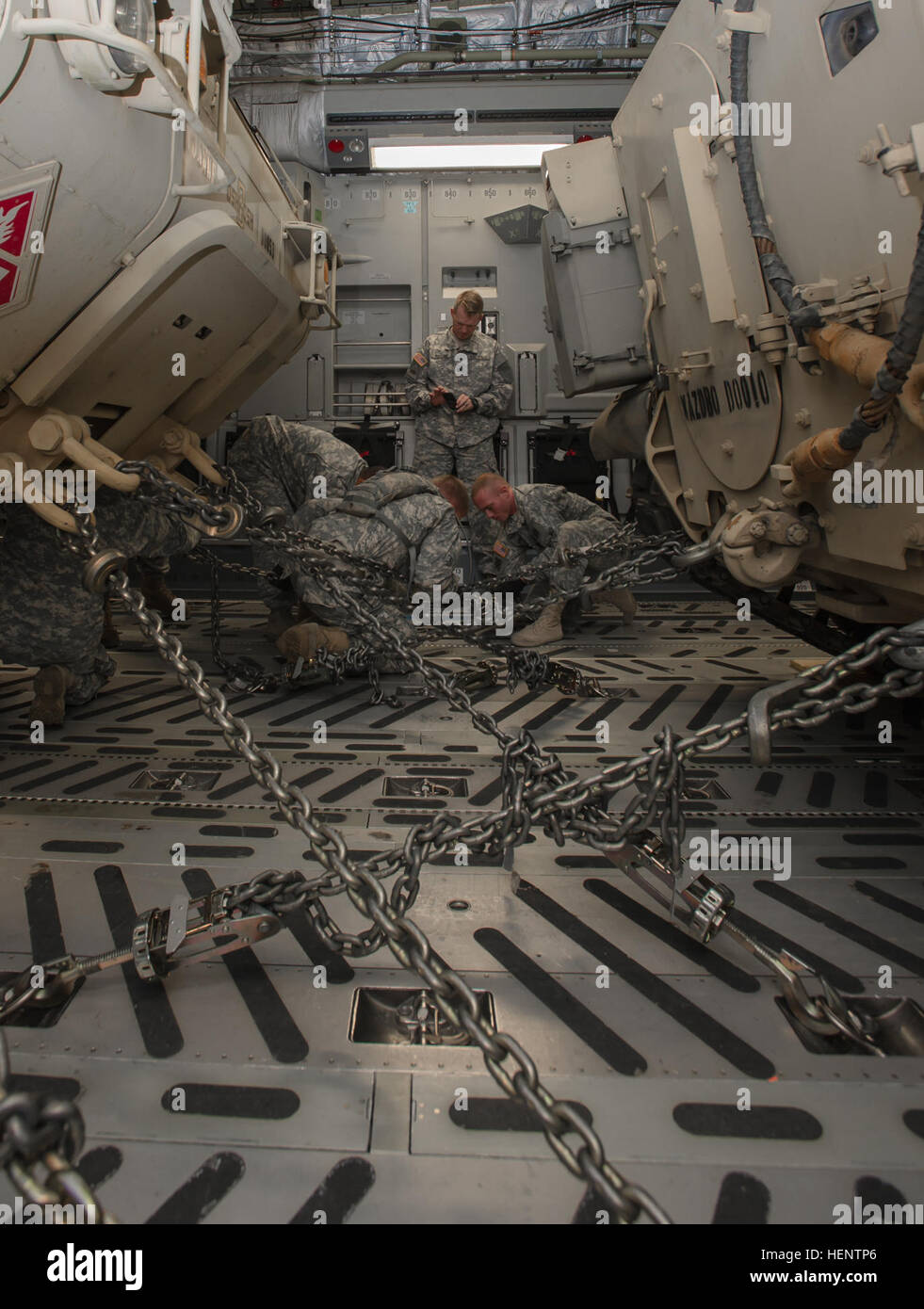 Soldiers from the 1st Battalion, 64th Armor Regiment “Desert Rogues”, 2nd Armored Brigade Combat Team, 3rd Infantry Division, work to chain down a M978A4 HEMTT Tanker and a M2A3 Bradley Infantry Fighting Vehicle to the belly of a C-17 Globemaster III from the 315th Airlift Wing, US Air Force Reserve Command, during the1-64th AR’s Emergency Deployment Readiness Exercise held at Hunter Army Airfield Sept. 24. The EDRE is an exercise designed to force a unit to put into practice all the steps they would actually have to go through if the unit were to be ordered to deploy on short notice. (U.S. Ar Stock Photo