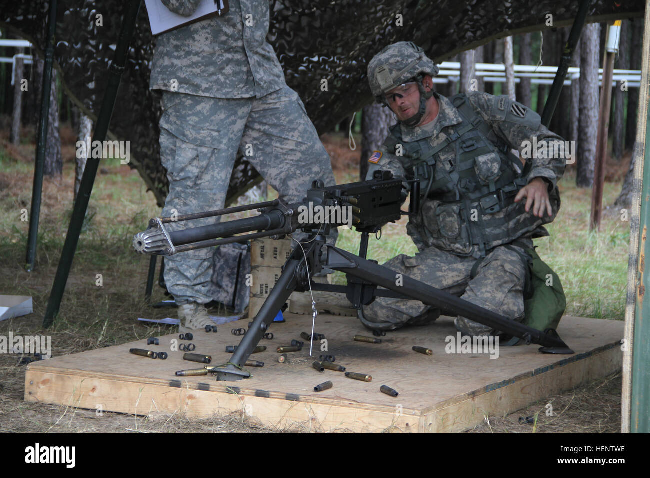 A 3rd Infantry Division infantryman demonstrates the proper use of the M2 .50 cal machine gun during Expert Infantryman’s Badge testing on Fort Stewart, Ga., Sept. 28, 2014. EIB testing consists of Army Physical Fitness Test, a day and night land navigation course, tests on weapons mastery skills, three individual tactical test lanes, and complete a 12-mile foot march within three hours. (U.S. Army Photo by Sgt. Joshua Laidacker, 4th IBCT, 3rd ID, Public Affairs) 96 expert infantrymen earn proficiency badge on Fort Stewart 140928-A-ZG315-268 Stock Photo