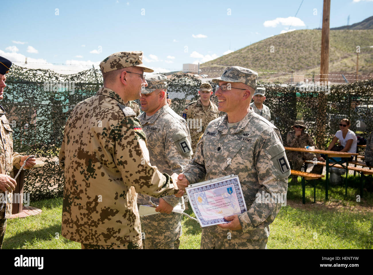 Lt. Col. Martin Herter, the German Air Defense Center deputy commander, presents Lt. Col. Robert Wagner, 402nd Field Artillery Brigade deputy commander, with a certificate during the German Weapons Badge awards ceremony at the Benavidez-Patterson “All Airborne” Chapter building in El Paso, Texas, recently. Wagner upgraded his badge from silver to gold. (Photo by Sgt. 1st Class David Parish, 5th Armored Brigade, Division West Public Affairs) Fort Bliss Soldiers earn German Weapons Proficiency Badges 140929-A-ZZ999-001 Stock Photo