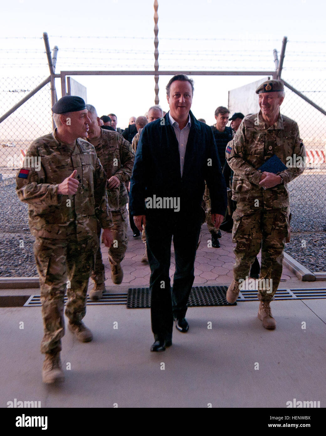 British Prime Minister David Cameron (center), British Maj. Gens. Richard Nugee, International Security Assistance Force Joint Command chief of staff (left) and Ben Bathurst, ISAF deputy advisor to the Afghan Ministry of Defense (right), walk into Kabul International Airport Oct. 3, 2014. During his surprise visit to Kabul, Cameron highlighted the success of British combat and training operations in Afghanistan. “They have done vital work here,” Cameron said. “We have trained up an effective Afghan army and police force. It has been hard, patient work.” British prime minister makes surprise vi Stock Photo
