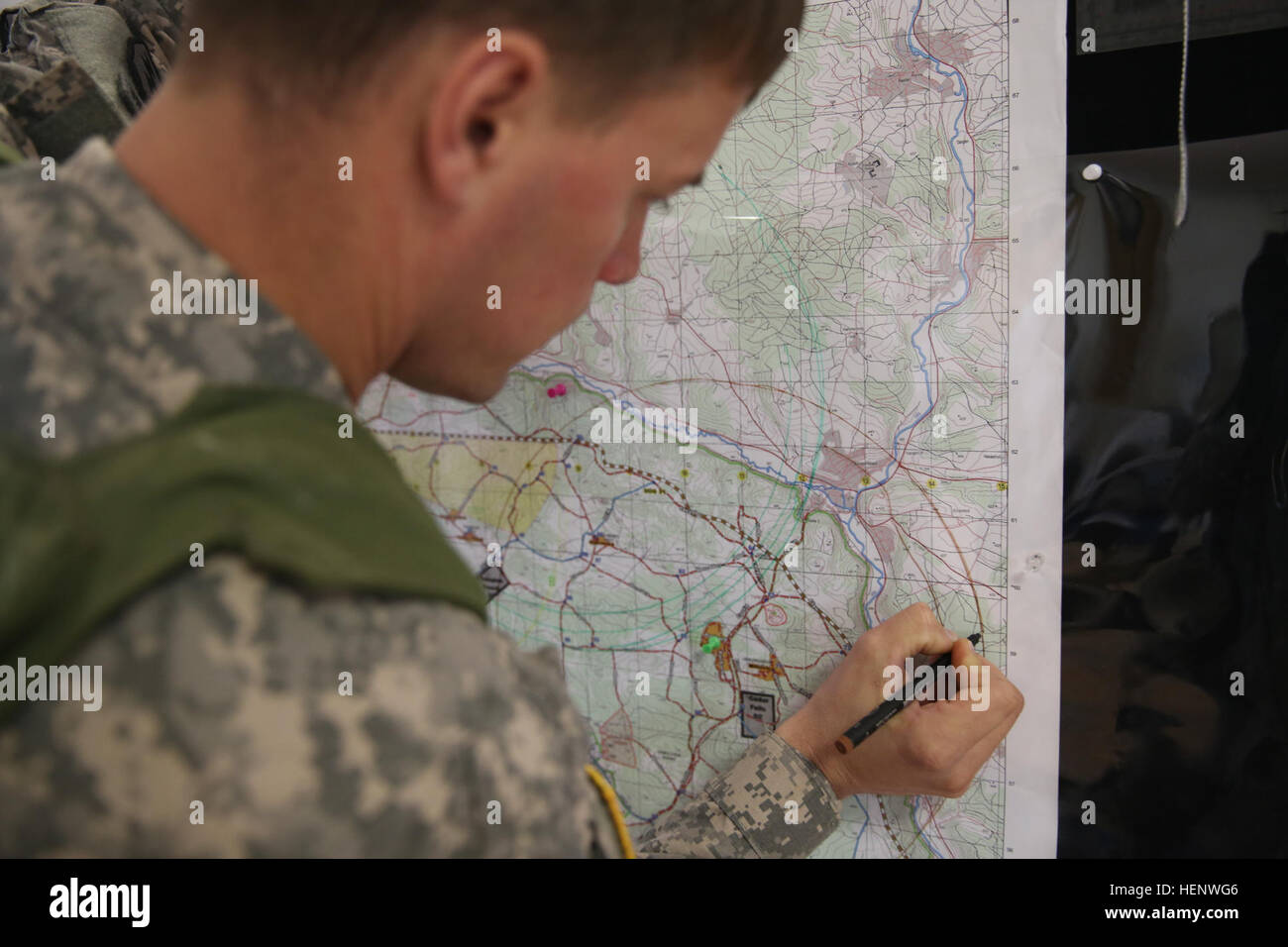 A U.S. Soldier assigned to Alpha Troop, 1st Squadron (Airborne), 40th Cavalry Regiment plots points on a map while conducting tactical operations center (TOC) operations during Rotation 14-09 at the Joint Multinational Readiness Center (JMRC) in Hohenfels, Germany, Oct. 07, 2014. The rotation is based on the current operational environment and is designed to prepare the unit for peace support, stability, and contingency operations. (U.S. Army photo by Spc. Brian Chaney/Released) Rotation 14-09 141007-A-EM978-001 Stock Photo