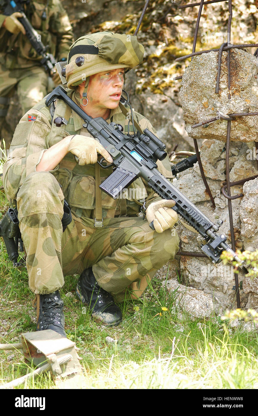 A Norwegian Army soldier takes cover behind a wall from incoming opposing force insurgent fire in the Joint Multinational Readiness Center training area in Hohenfels, Germany, May 13, 2008. The NATO Operational Mentorship and Liaison Team is preparing the soldiers for unit readiness prior to a deployment. (U.S. Army photo by Spc. Kalie Frantz/Released) Norwegian AG-3 Stock Photo