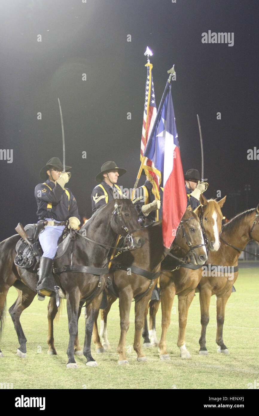 Troopers with the U.S. Army’s 1st Cavalry Division Horse Detachment present the national colors in front of more than 500 attendees during a high school football game at Burnet, Texas, Oct. 24. Prior to kickoff, the 1st Air Cavalry Brigade, 1st Cav. Div.’s leadership was recognized for their community partnership with the city of Burnet, and the 1st Cav. Div. Horse Detachment delivered the game ball. First Team honored during high school football game 141024-A-WD324-036 Stock Photo