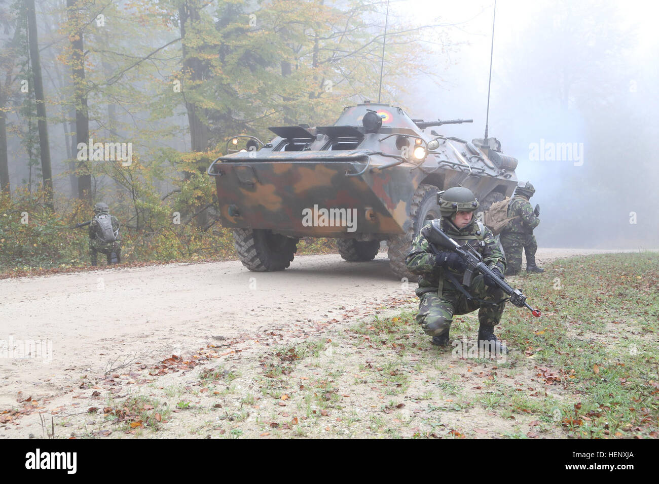 Romanian soldiers of Bravo Company, Infantry Battalion provide security next to a TABC-79 armored personnel carrier during exercise Combined Resolve III at the Joint Multinational Readiness Center in Hohenfels, Germany, Oct. 25, 2014.  Combined Resolve III is a multinational exercise, which includes more than 4,000 participants from NATO and partner nations, and is designed to provide a complex training scenario that focuses on multinational unified land operations and reinforces the U.S. commitment to NATO and Europe. (U.S. Army photo by Sgt. Ian Schell/Released) Combined Resolve III 141025-A Stock Photo