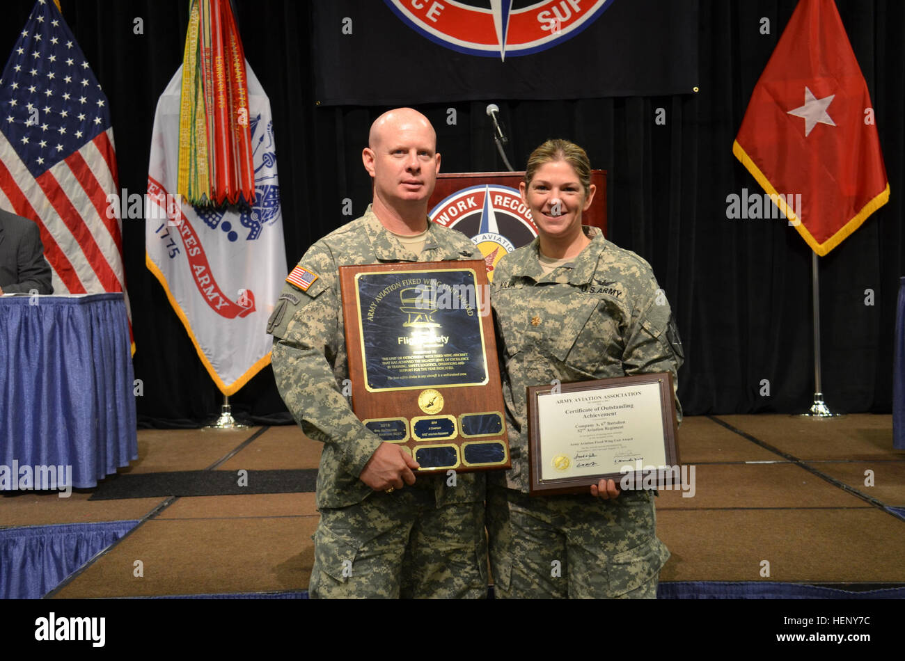 Maj. Courtney Kiluk and 1st. Sgt. Casey Roberts receive the Fixed-Wing Unit of the Year Award at the 2014 AAAA Annual Professional Forum Nov. 6 in Huntsville, Ala. Fixed-Wing Unit of the Year Award 141124-A-AB123-003 Stock Photo