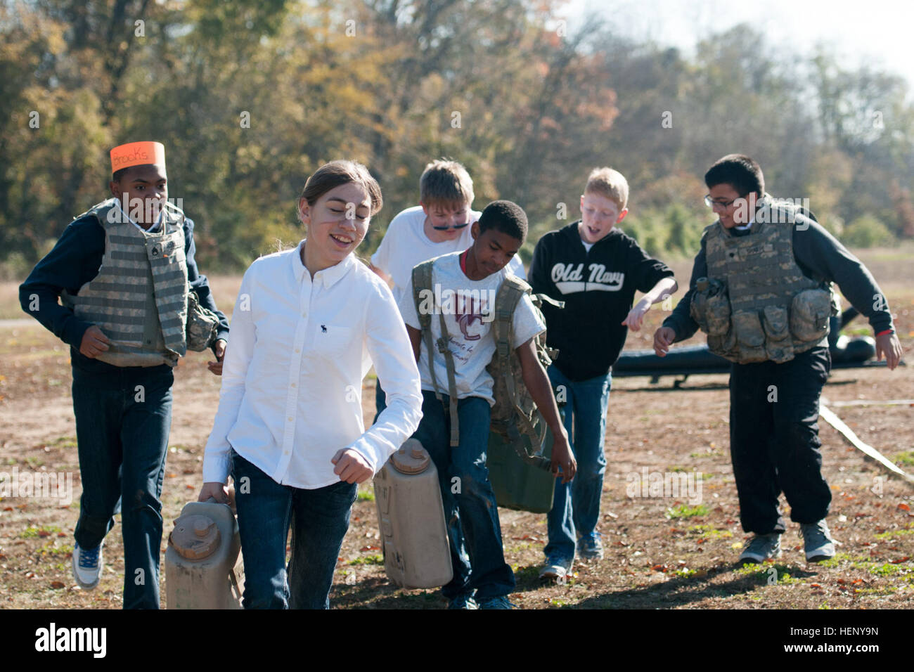 Students from West Creek Middle School in Clarksville, Tenn., carry water cans as part of an obstacle course set up by the 551st Military Police Company, 716th Military Police Battalion, 16th Military Police Brigade, supported by the 101st Sustainment Brigade, 101st Airborne Division, for a Veterans Day event Nov. 7 at West Creek Middle School. The school partnered with the MP battalion to honor veterans and to give students an opportunity to participate in different events to show students what it’s like to be part of the U.S. Army. (U.S. Army photo by Sgt. Leejay Lockhart, 101st Sustainment  Stock Photo