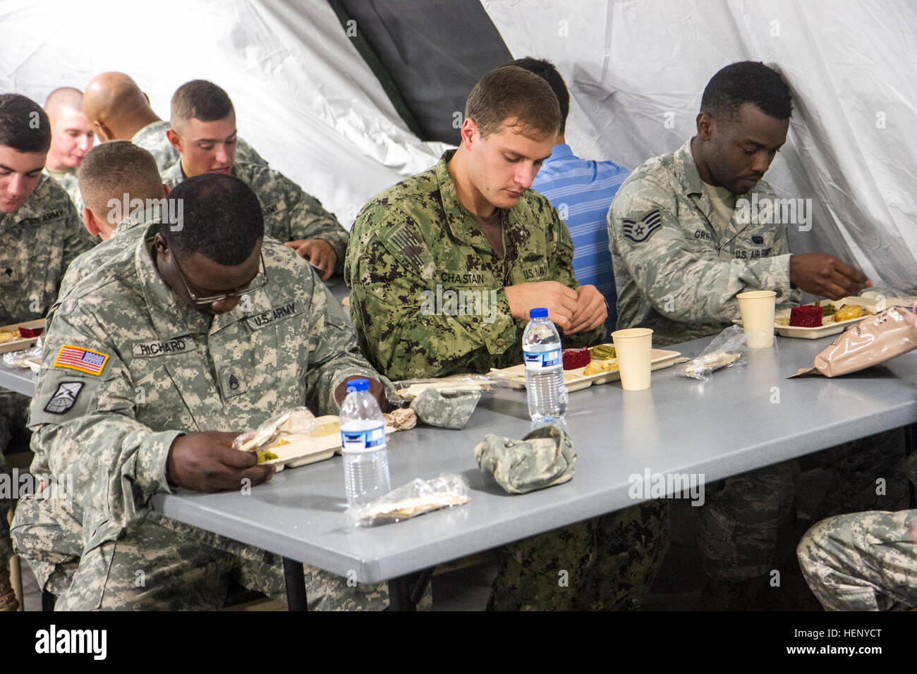 Service members partake in the first hot meal on Barclay Training Center Nov. 9, 2014, since arriving more than three weeks ago. The meal consisted of chicken potpie, a wheat biscuit, green beans, red velvet cake and grape juice. United Assistance is a Department of Defense operation to provide logistics, training and engineering support to U.S. Agency for International Development-led efforts to contain the Ebola virus outbreak in West African nations. (U.S. Army photo by Staff Sgt. Terrance D. Rhodes, Joint Forces Command – United Assistance Public Affairs/RELEASED) Service members in Liberi Stock Photo