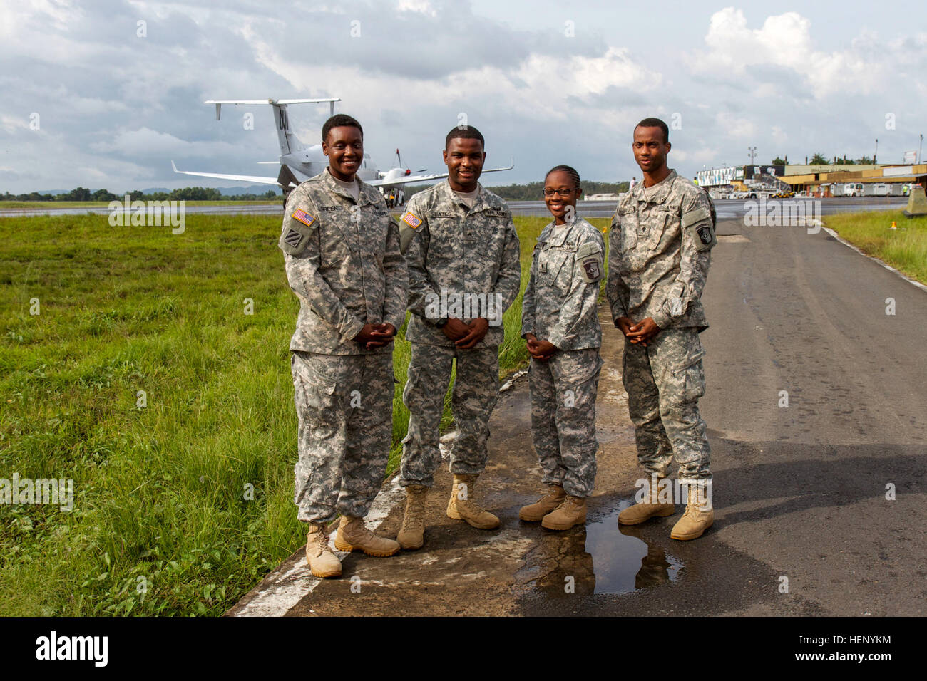 From left, a team of four Soldiers, Sgt. Lia Green, Cpl. Kenardo Bates, Spc. Clinton Bowles and Spc. Tessica Charles, all with the 101st Sustainment Brigade Human Resources Company, Fort Campbell, Ky., stand ready to support every service member and Department of Defense employee arriving or departing Liberia for the Joint-Forces Command – United Assistance Nov. 14, 2014. The Soldiers have in-processed more than 2,000 incoming personnel as of Nov. 14, 2014, and assure they receive safe transportation to their areas of operation in West Africa. Operation United Assistance is a Department of Def Stock Photo