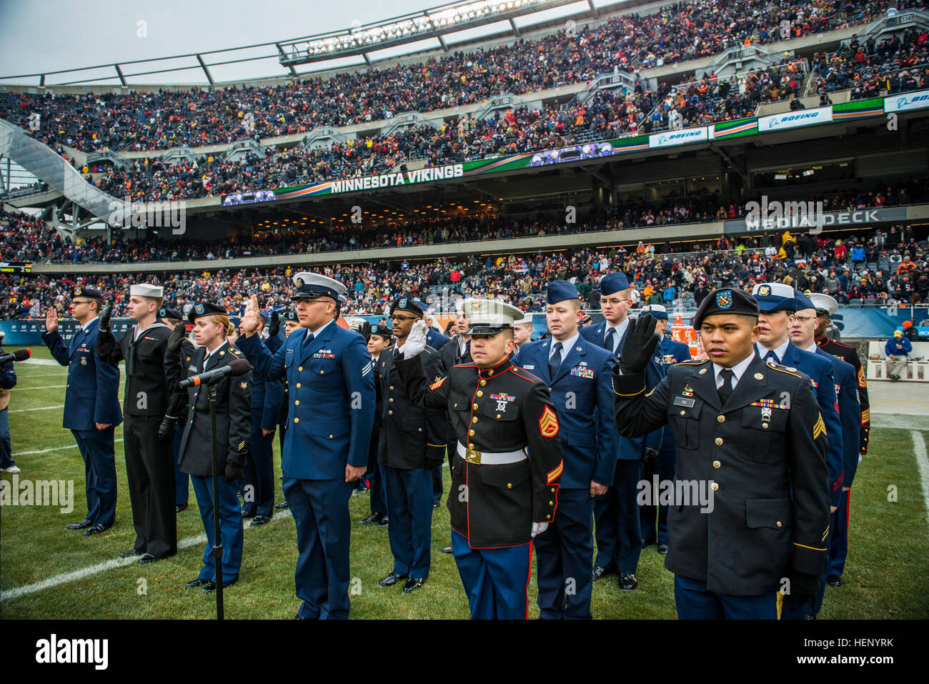 A group of service members recite the oath of enlistment during a reenlistment ceremony at Soldier Field during an NFL game designated to honor troops, Nov. 16., a few days after Veterans Day. (U.S. Army photo by Sgt. 1st Class Michel Sauret) Military service members honored during Chicago Bears game 141116-A-TI382-723 Stock Photo