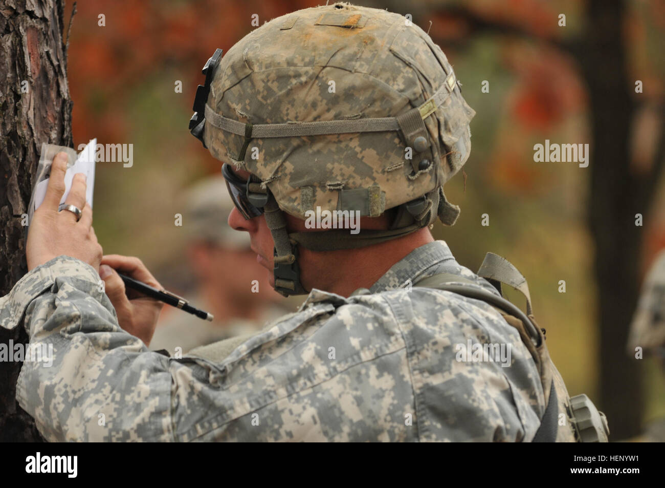 A paratrooper assigned to the 82nd Airborne Division plots points on his map during the land navigation event for Expert Infantry Badge testing on Fort Bragg, N.C., Nov. 17, 2014. The 2nd Battalion, 325th Airborne Infantry Regiment, 2nd Brigade Combat Team, hosted EIB testing this week for candidates to prove their proficiency in the infantry profession. (82nd Airborne Division photo by Sgt. Eliverto V. Larios/Released) Falcons host Expert Infantry Badge Testing for Fort Bragg Soldiers 141117-A-ZK259-309 Stock Photo