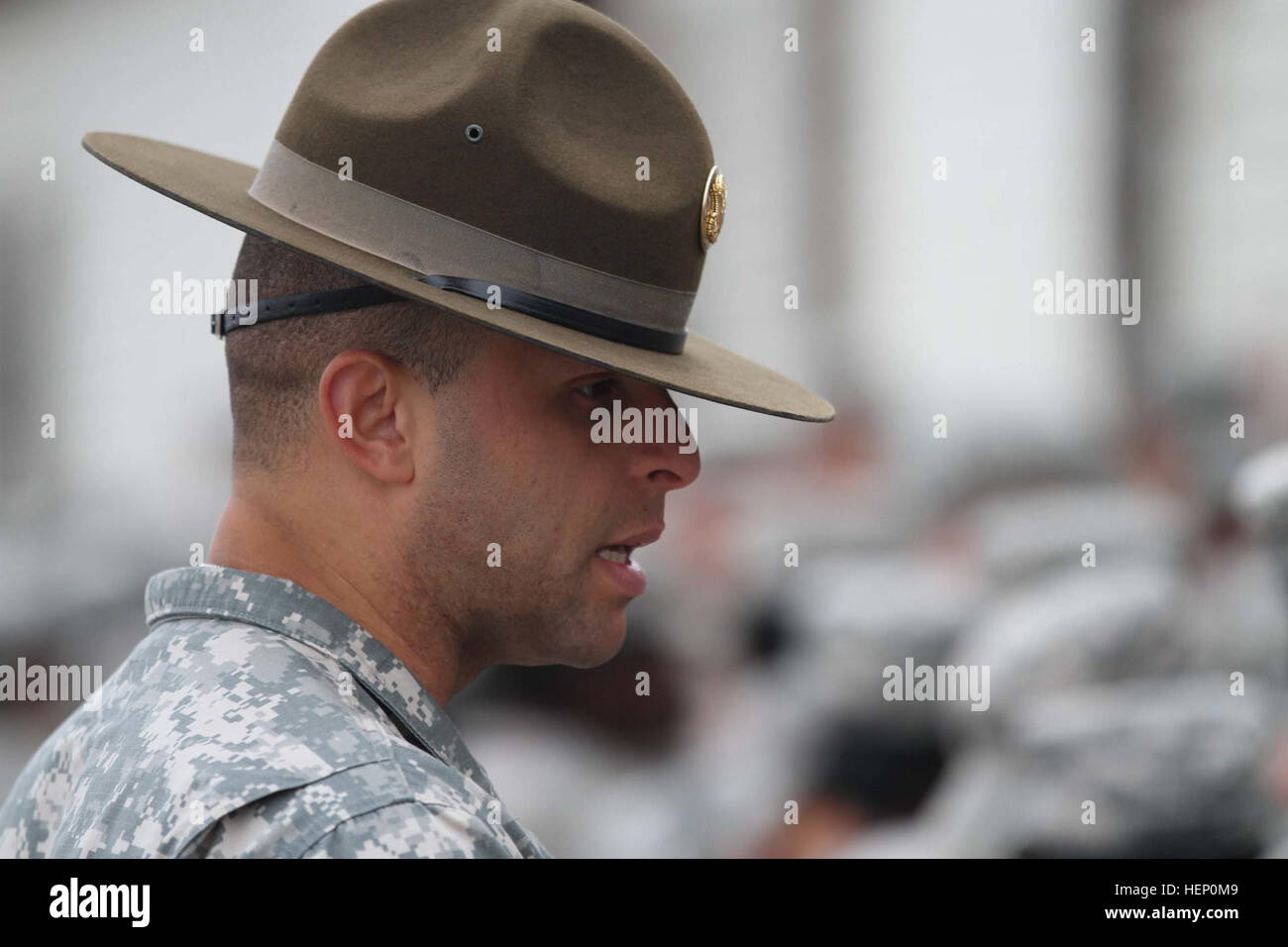 The olive drab headgear worn by male drill sergeants today has a flat brim, Montana Peak and bears a gold disc of the Great Seal of the United States on its front. Infantry Soldiers wear an infantry blue disc under the seal. Drill sergeants first wore this hat in 1964 as a way of distinguishing themselves from those whom they were charged with transforming into Soldiers. It has been their proud symbol ever since. A legendary symbol of pride 141204-A-OY832-705 Stock Photo