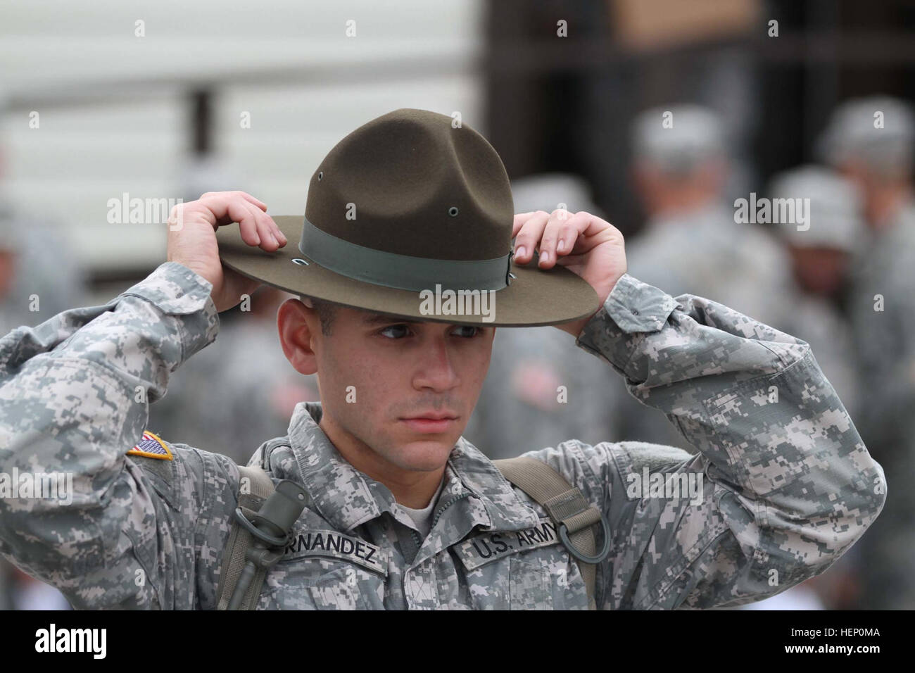 Drill sergeant candidates at the United States Army Drill Sergeant School are fitted and issued their hats just days before graduating from the prestigious course. The olive drab headgear worn by male drill sergeants today has a flat brim, Montana Peak and bears a gold disc of the Great Seal of the United States on its front. Infantry Soldiers wear an infantry blue disc under the seal. Drill sergeants first wore this hat in 1964 as a way of distinguishing themselves from those whom they were charged with transforming into Soldiers. It has been their proud symbol ever since. A legendary symbol  Stock Photo