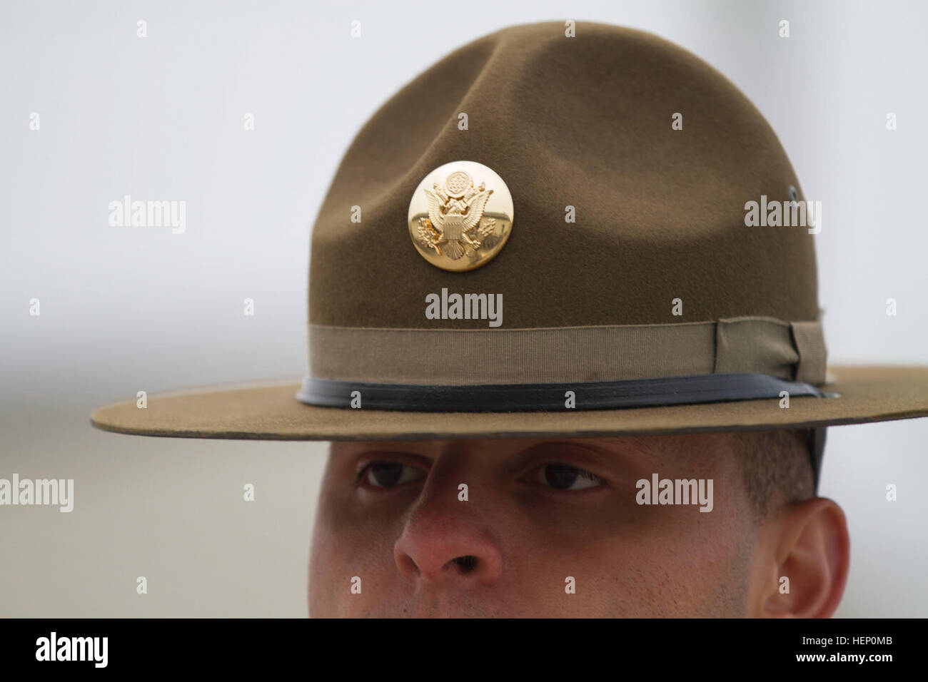 The olive drab headgear worn by male drill sergeants today has a flat brim, Montana Peak, and bears a gold disc of the Great Seal of the United States on its front. Infantry Soldiers wear an infantry blue disc under the seal. Drill sergeants first wore this hat in 1964 as a way of distinguishing themselves from those whom they were charged with transforming into Soldiers. It has been their proud symbol ever since. A legendary symbol of pride 141204-A-OY832-867 Stock Photo