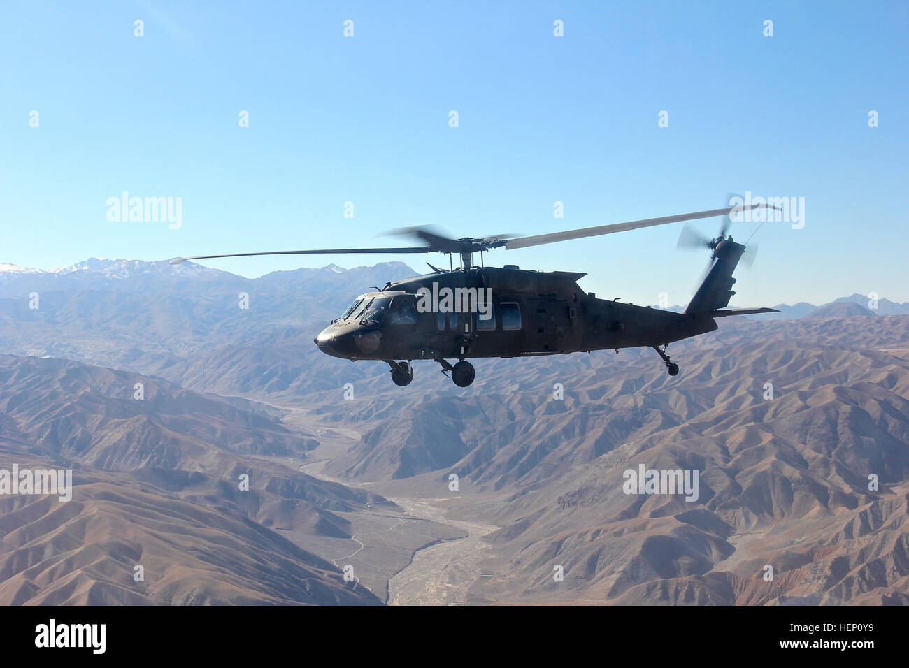 A UH-60 Black Hawk helicopter assigned to Task Force Wolfpack, 1st Attack Reconnaissance Battalion, 82nd Combat Aviation Brigade, 82nd Airborne Division flies high over the rugged landscape of eastern Afghanistan on clear day Dec. 8, 2014. 1-82 ARB flies high in east Afghan skies 141208-A-VO006-633 Stock Photo